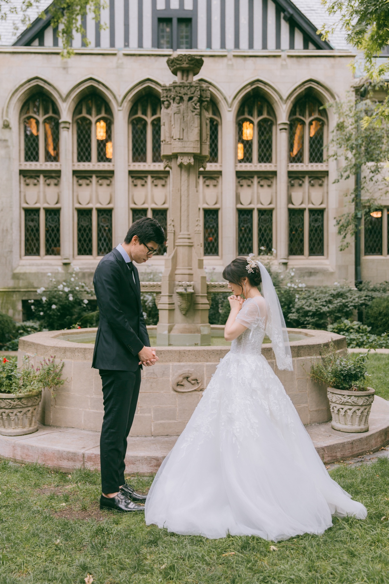 A couple holding hands in a church courtyard
