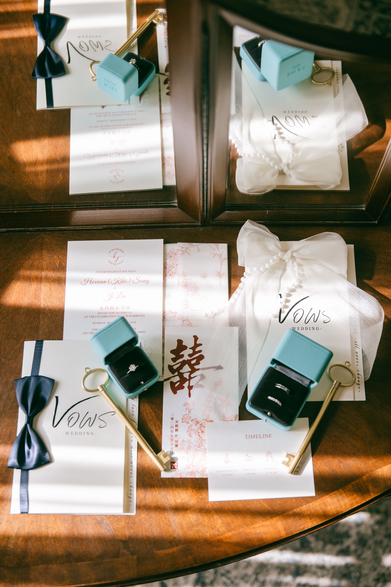 Wedding invitations, rings, bow ties, and keepsakes arranged on wood