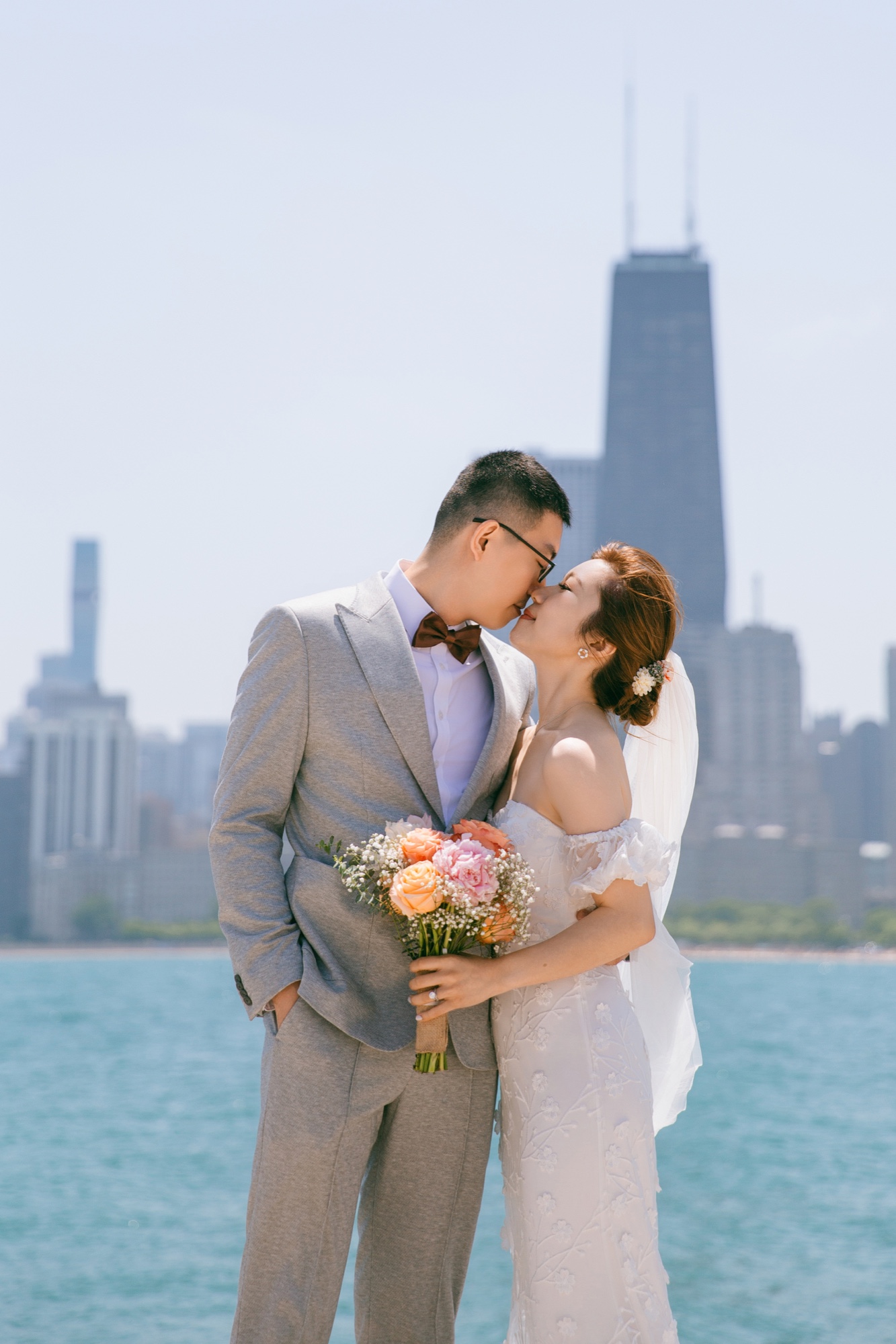 A couple kissing beside the Chicago lakefront skyline