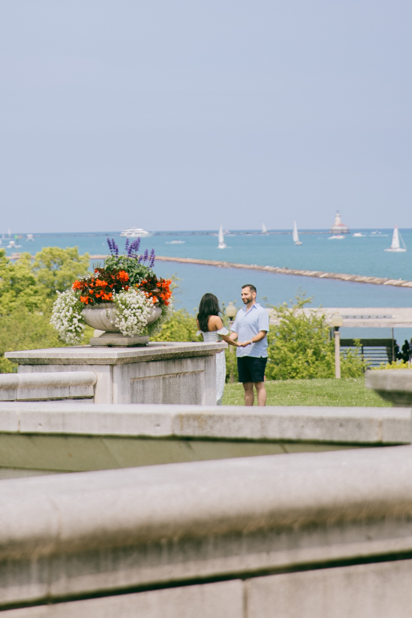A couple holding hands while overlooking Lake Michigan
